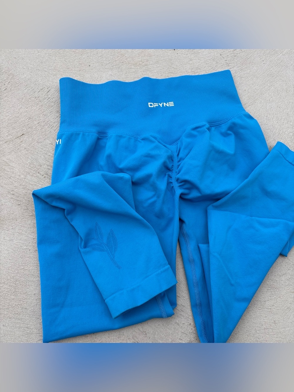 DFYNE Lanyi Edit Leaf Scrunch Leggings featuring electric blue leaf logo